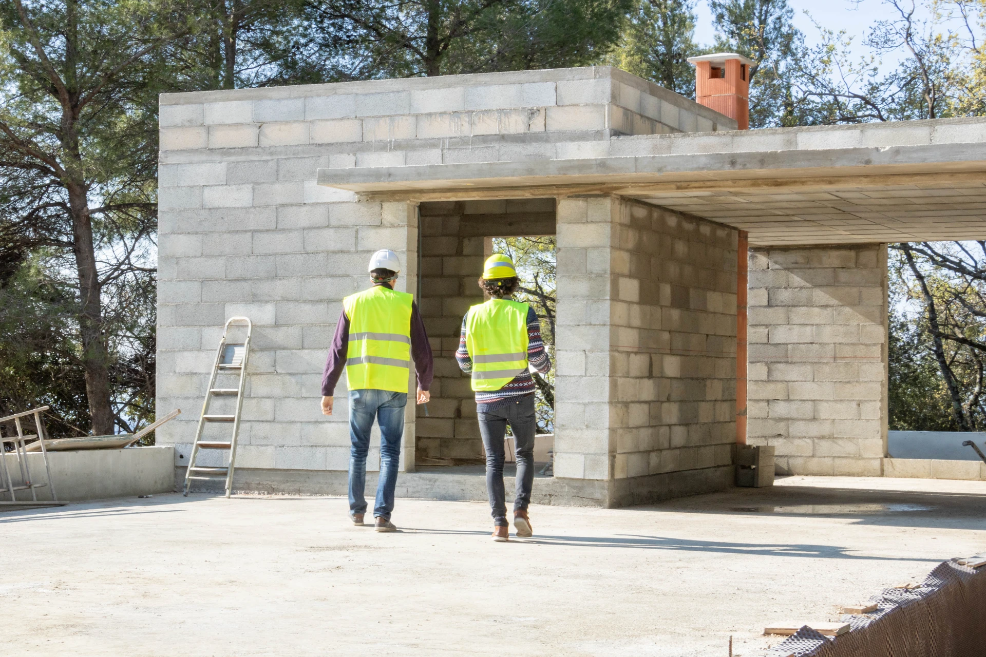 Chantier de terrassement en extérieur avec bulldozer jaune sur chenilles et pelleteuse hydraulique en arrière-plan